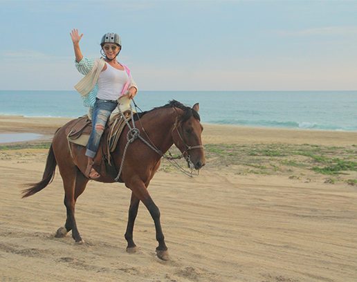 Gresa riding ahorse at the beach